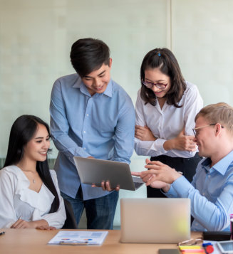 group of people looking in laptop