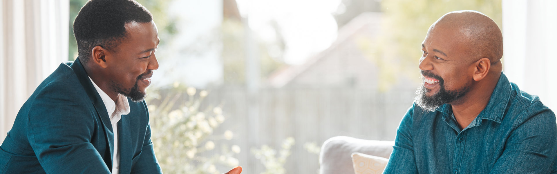 two men smiling at each other