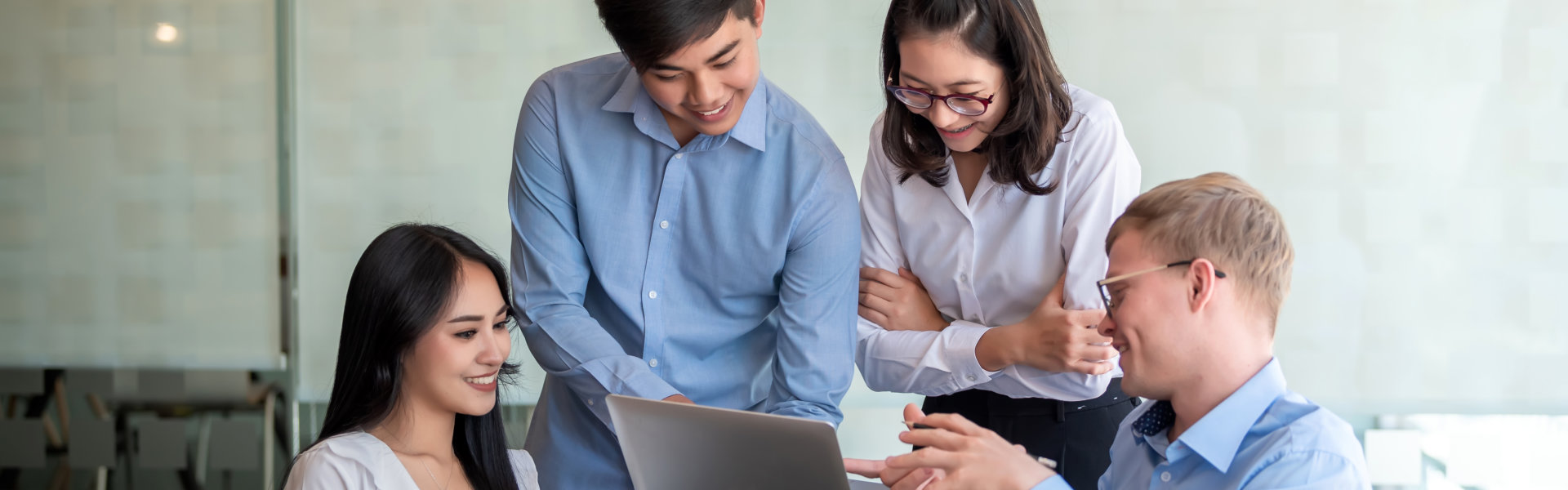 group of people looking in laptop