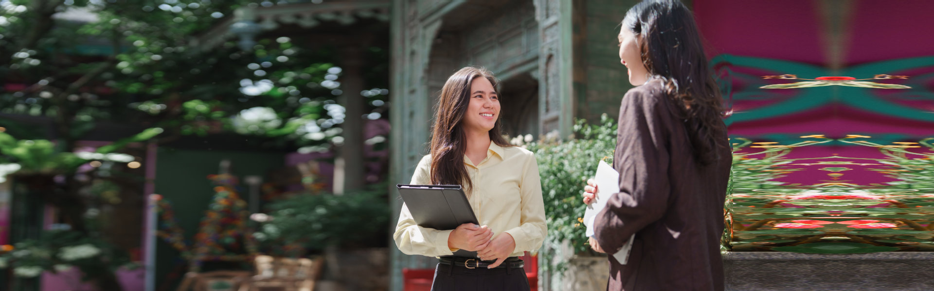 Young Women Discuss Business Outdoors